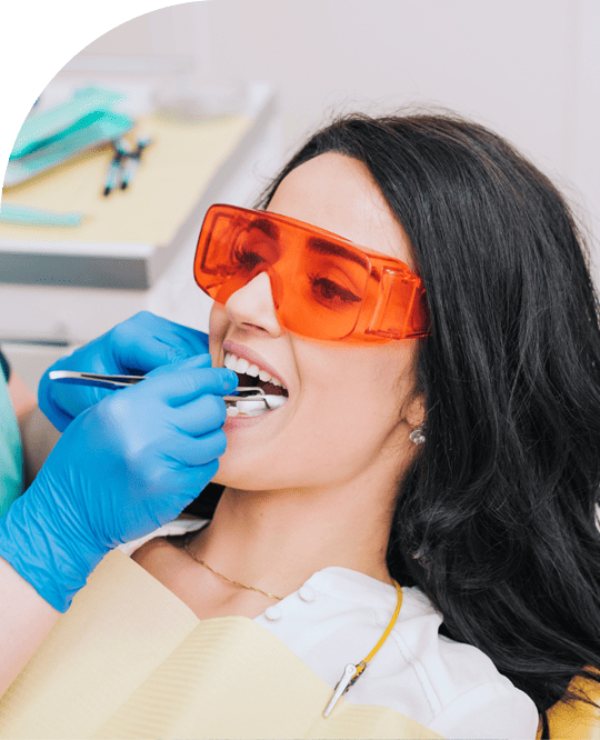Patient getting professional teeth whitening treatment